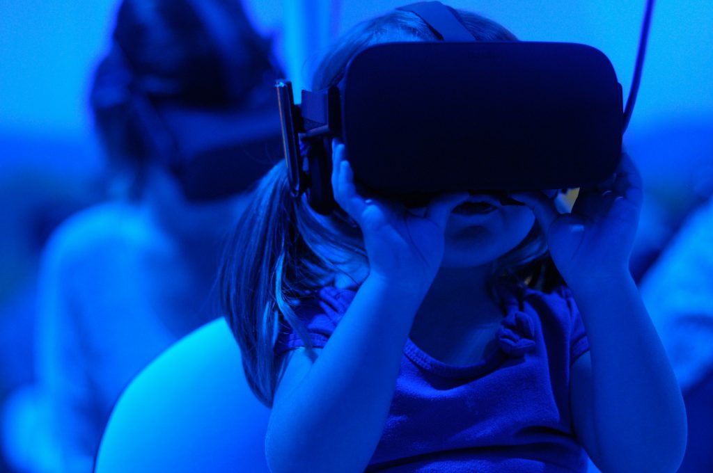 A little girl using VR glasses as a spatial video use cases